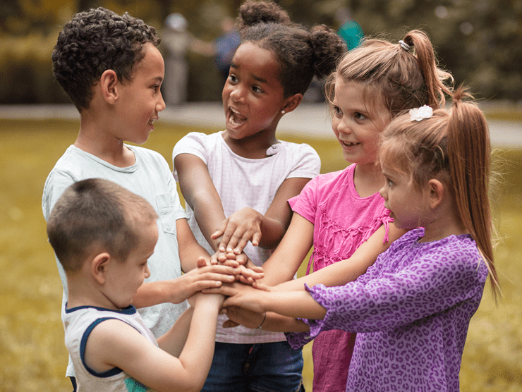 Group of young children holding hands