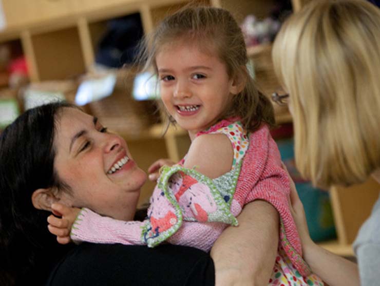 working mom picking up daughter at daycare