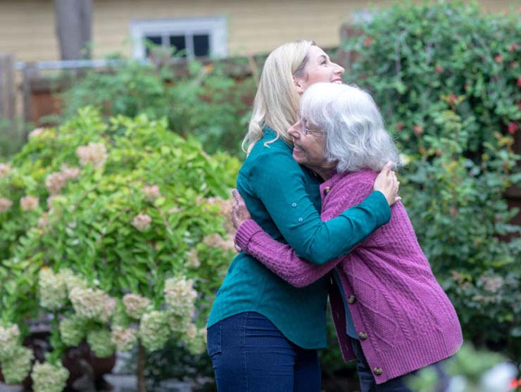 family hugging after pregnancy announcement