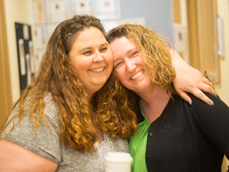 working moms maintaining friendship by hugging