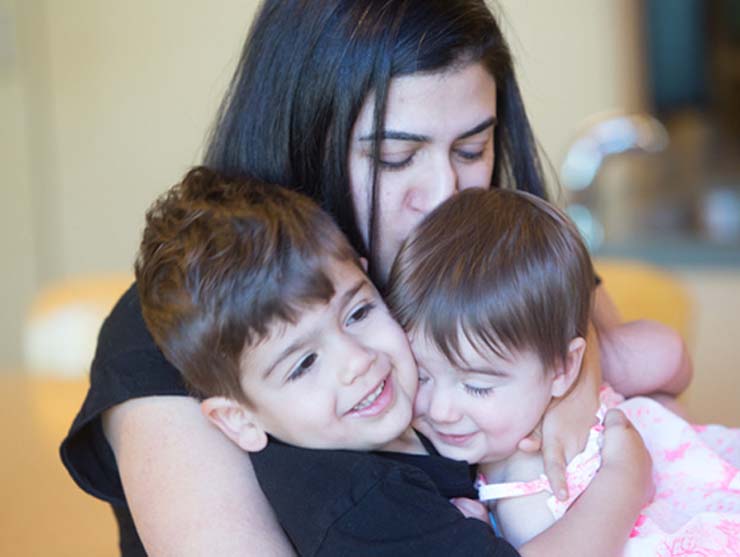 mom making children feel loved on Valentine's Day with kisses and hugs