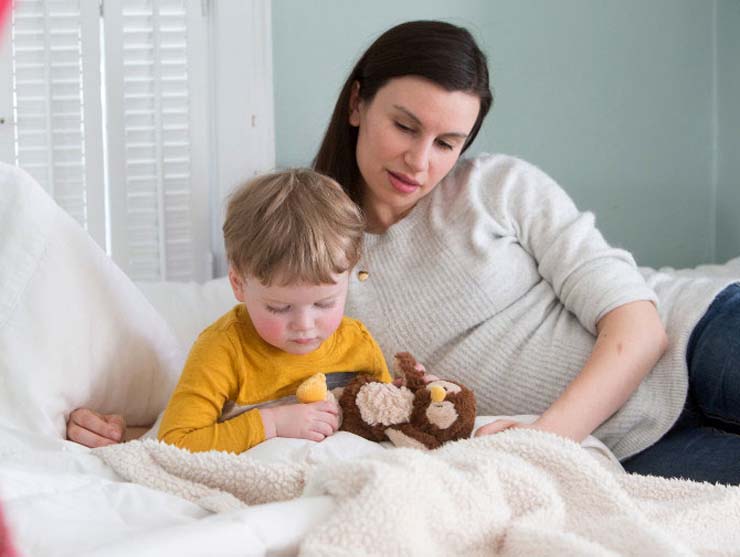preschool boy and mom reading a book about moving