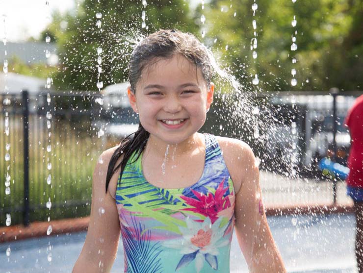 smiling girl enjoying summer camp water activity