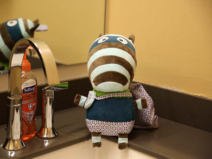 olly pop teaching children how to wash hands at a classroom sink
