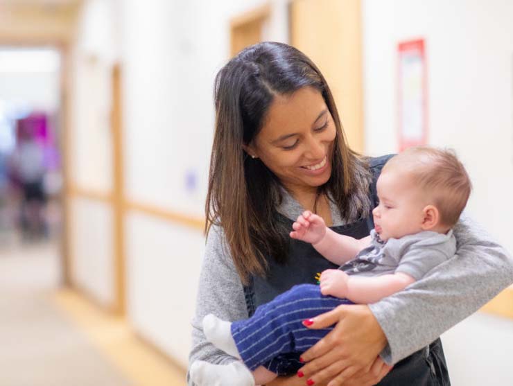 mom holding sleepy baby