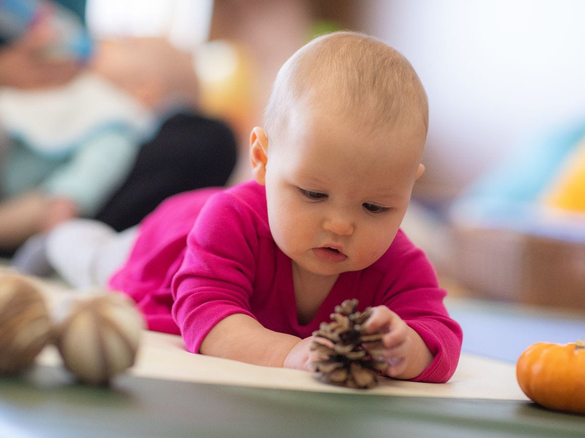 Baby in infant care classroom at Bright Horizons