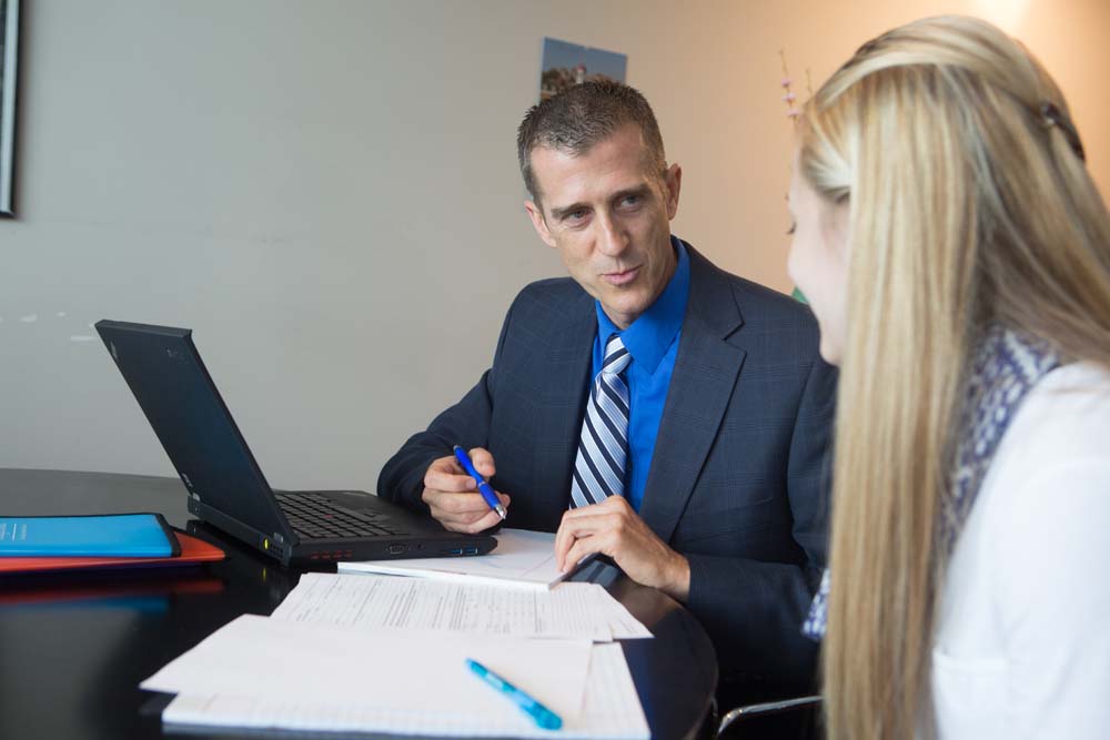 Professional working on letters of recommendation in an office setting