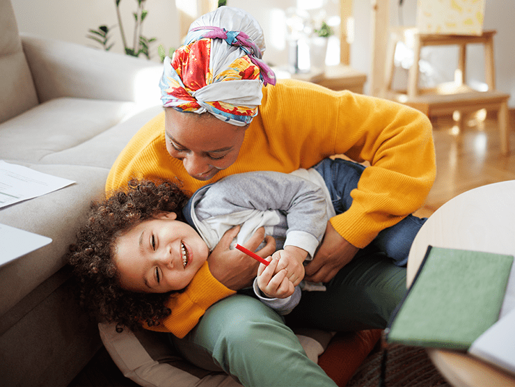 A mom and child playing together on the floor.
