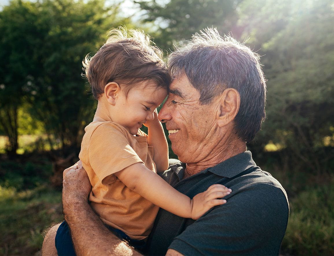 And grandpa and his toddler grandson forehead to forehead, smiling.