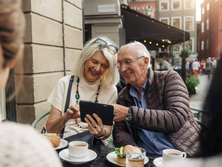 Two seniors looking at a tablet.