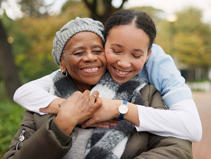 Young woman hugging and caring for an elder family member.