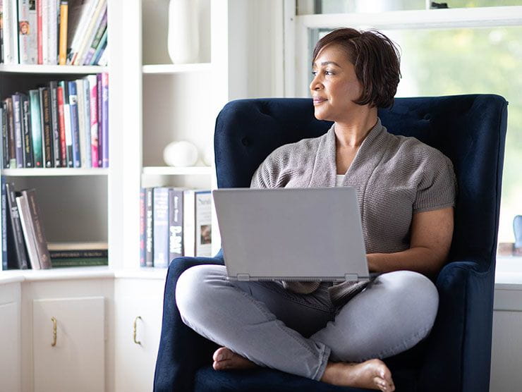 A woman looking at her window at home.