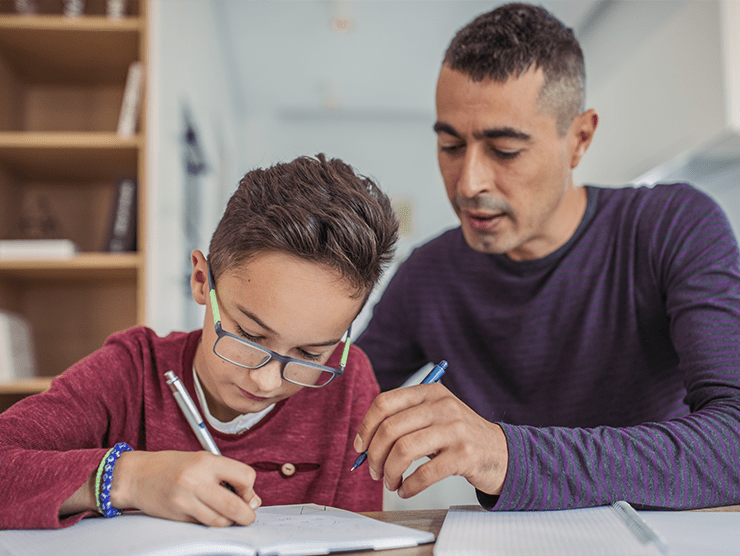 A father and son doing homework together.