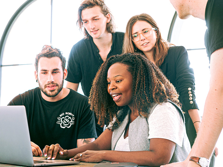 A group if coworkers looking at a screen.
