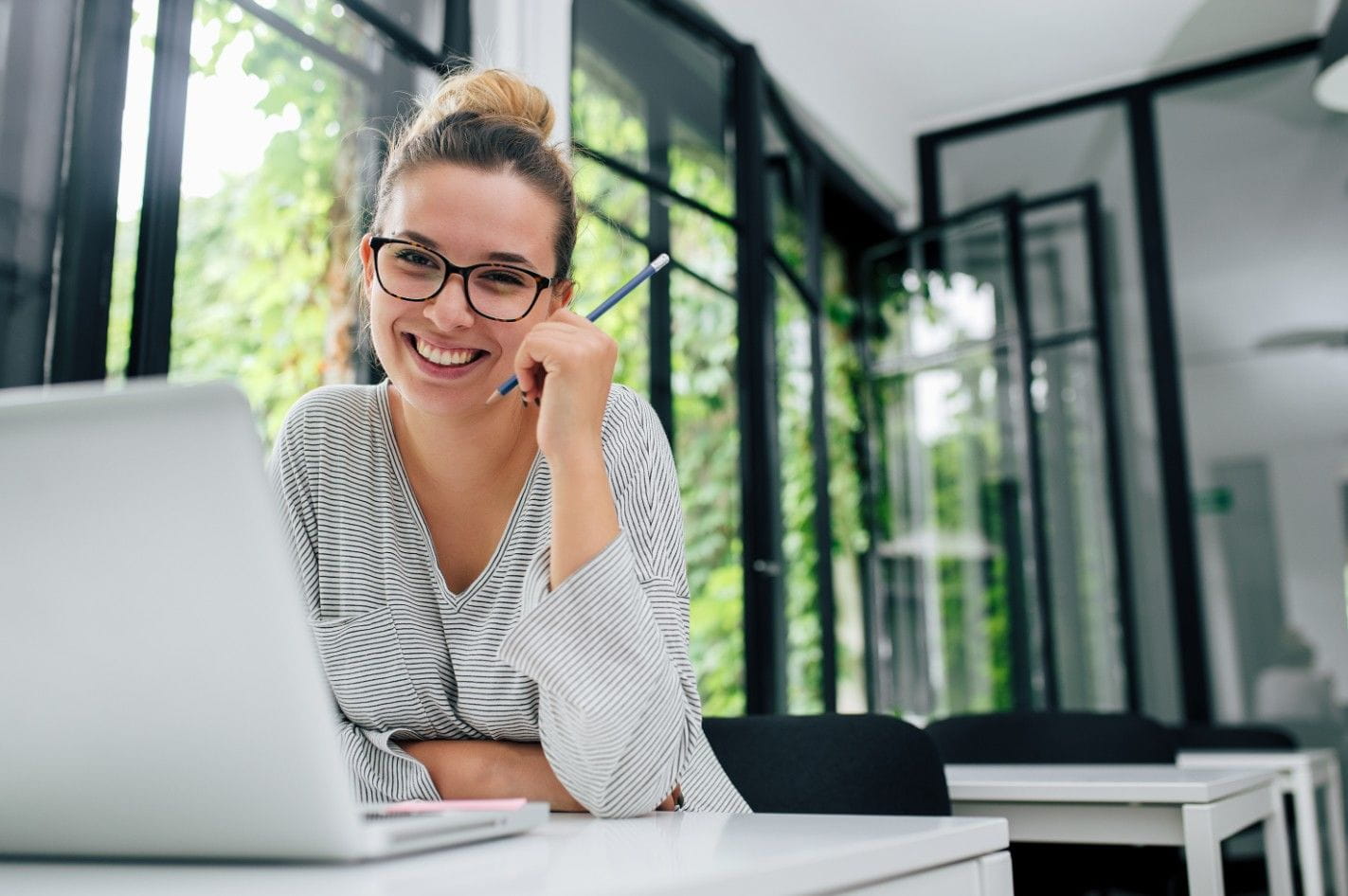 smiling woman working on laptop
