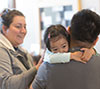 Young girl clinging to her dad