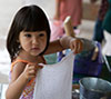 Preschooler washing dishes