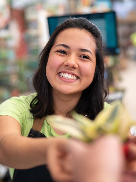 retail worker smiling while helping customer
