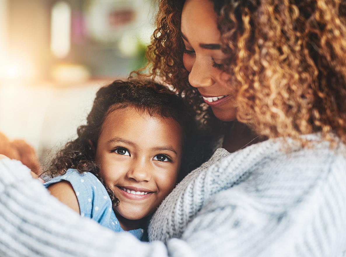 daughter smiling in the arms of mother