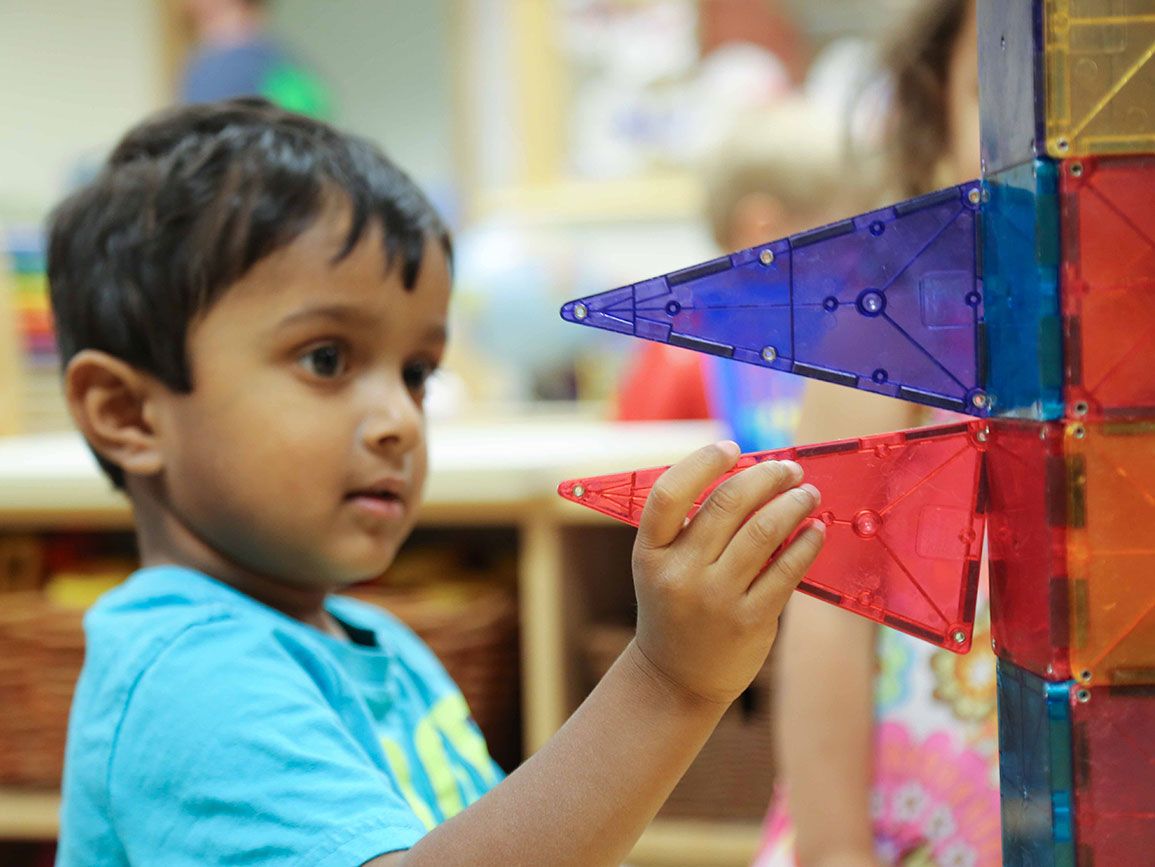 Toddler constructing using tiles