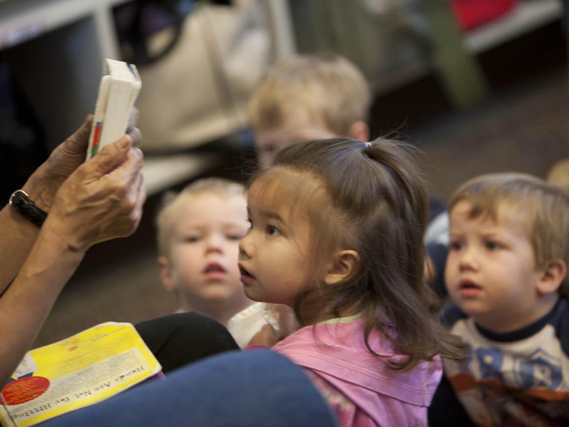 Children listening to a book being read at a child care center