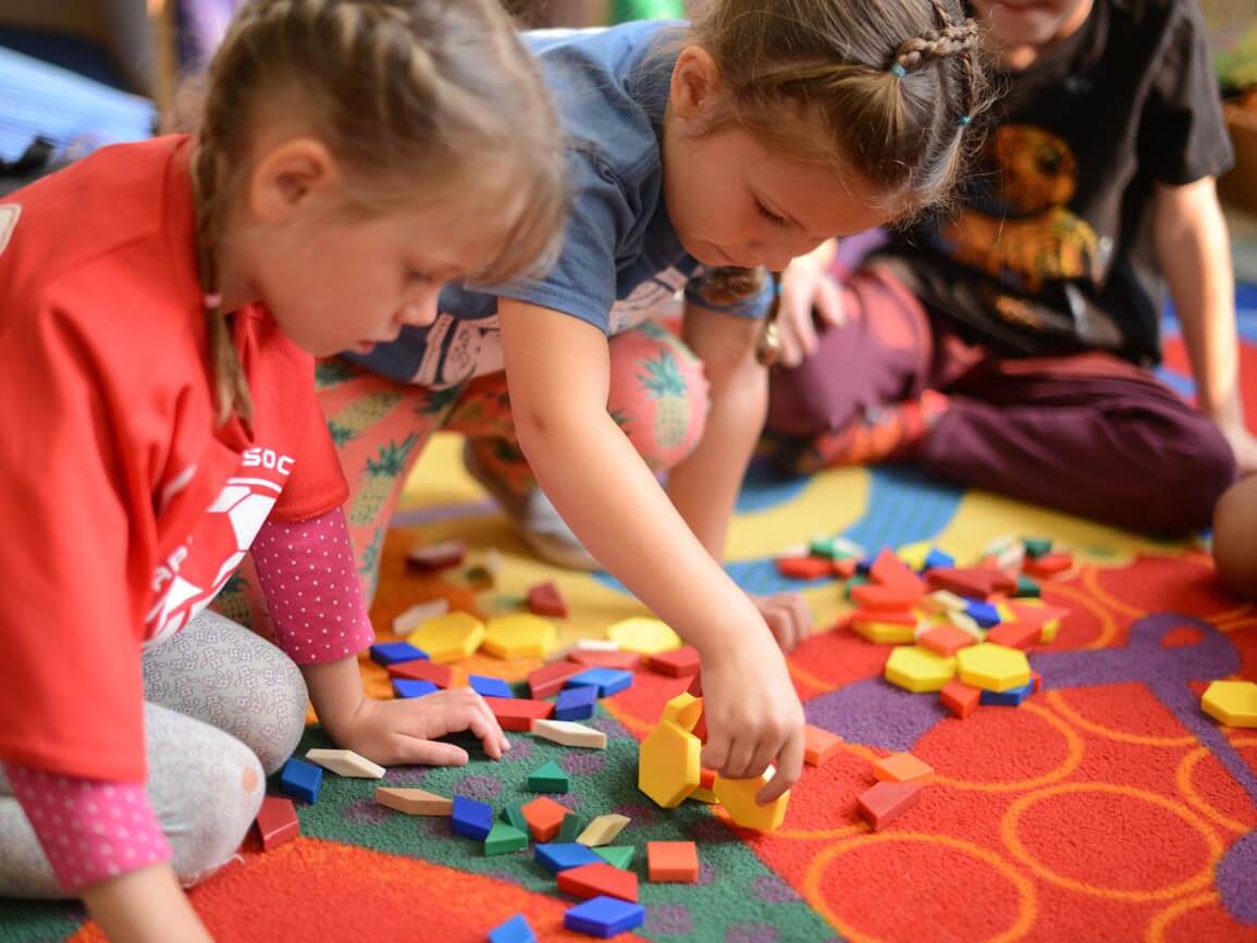 Children playing on the carpet together