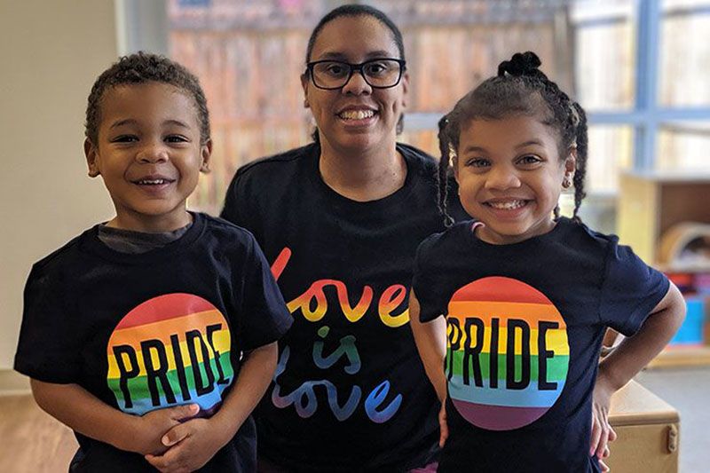 Center Director and her two children wearing pride shirts