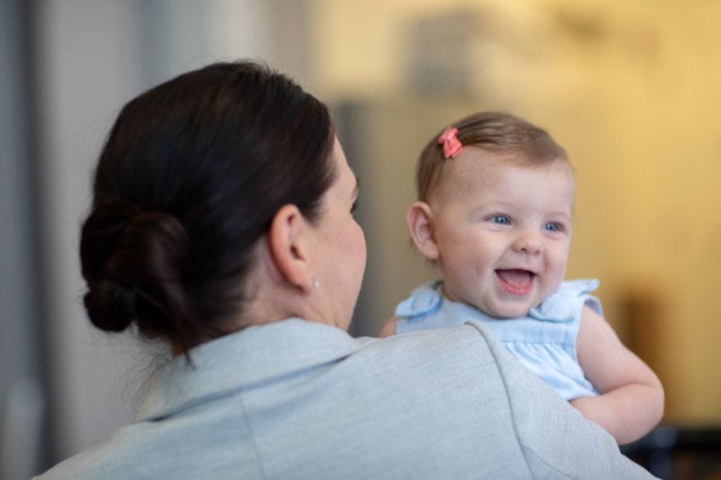 Working mom bringing her baby to back-up care