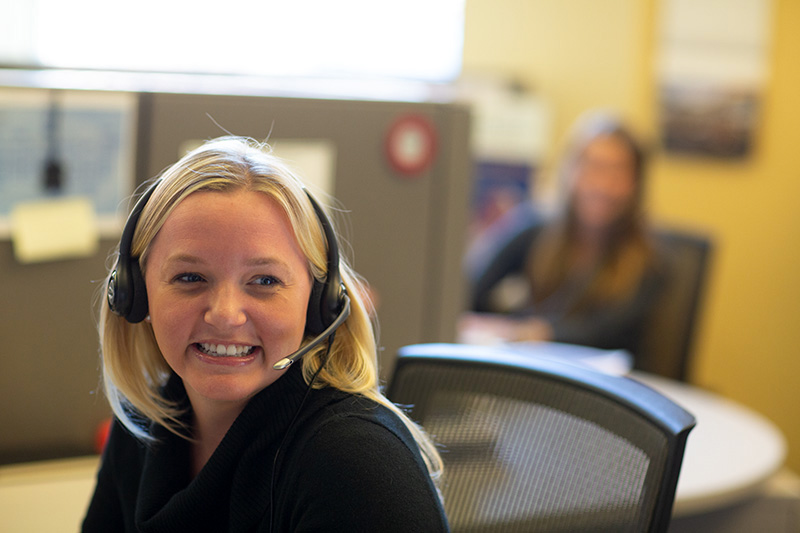 Happy call center employee assisting a customer