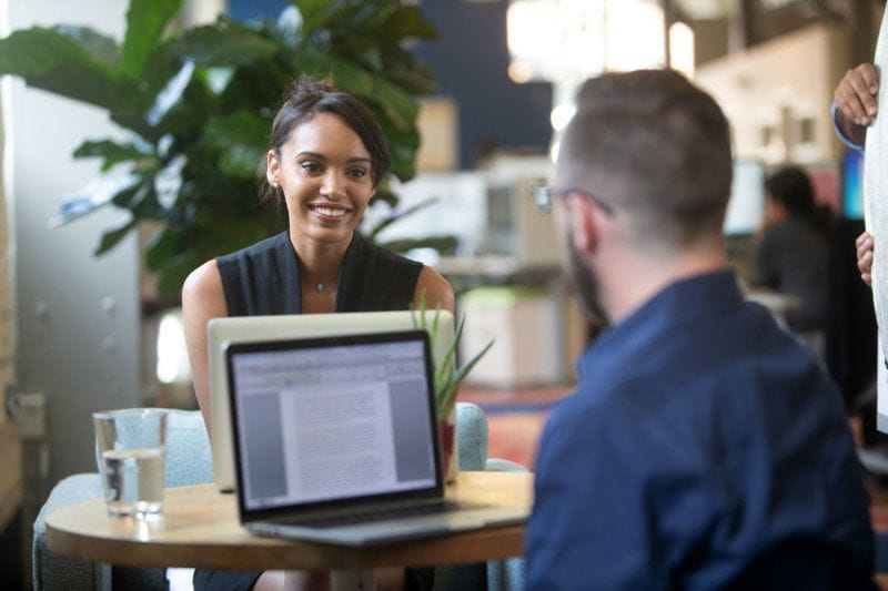 Young professional looking at tuition reimbursement information with the program manager