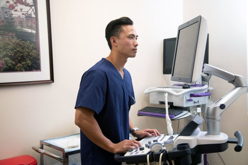 Male medical assistant using the computer