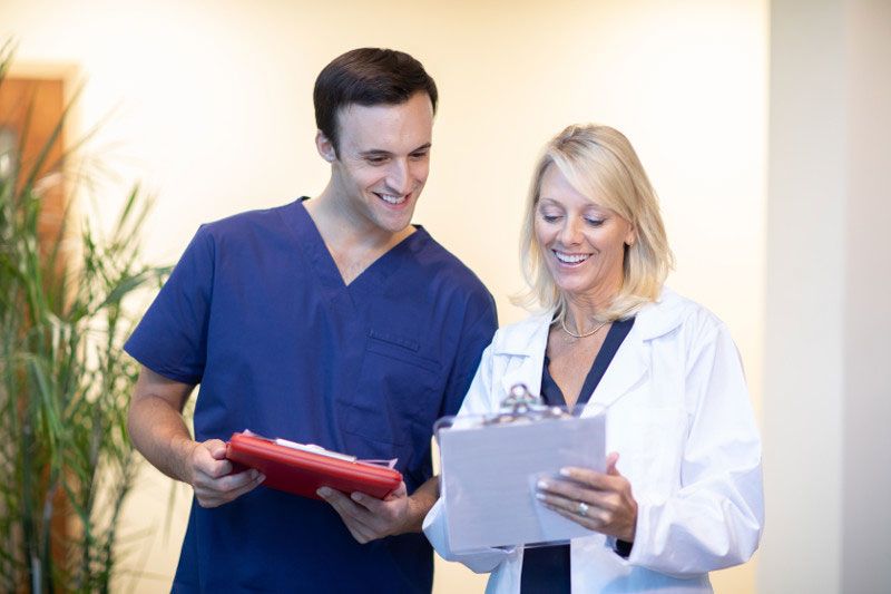 Nurse and doctor discussing a patient's chart