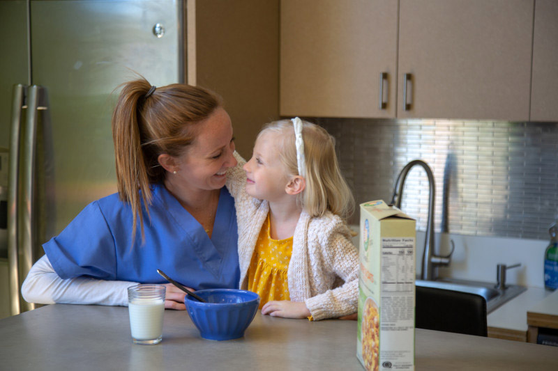 Healthcare employee at home with her daughter