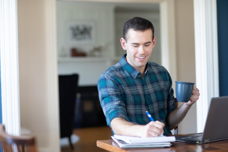 Adult learner at home happy that the student loan pause was extended
