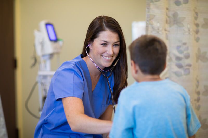 Female nurse taking care of a young boy