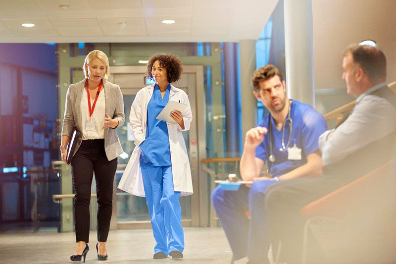 Healthcare professionals conversing in a hospital