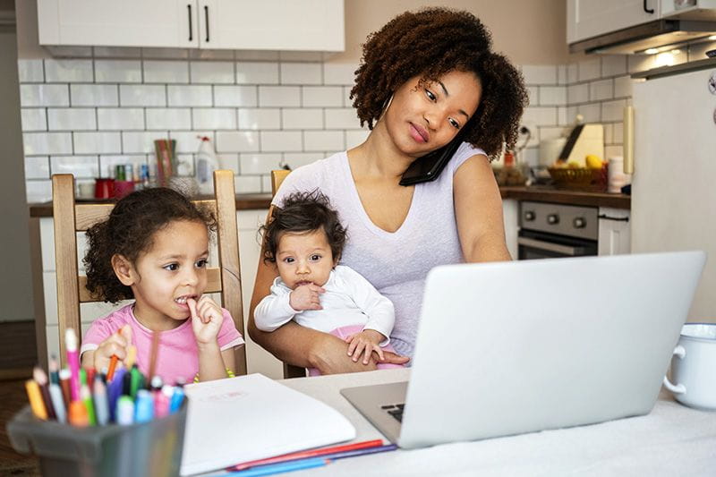 Mom trying to work from home while caring for her two kids