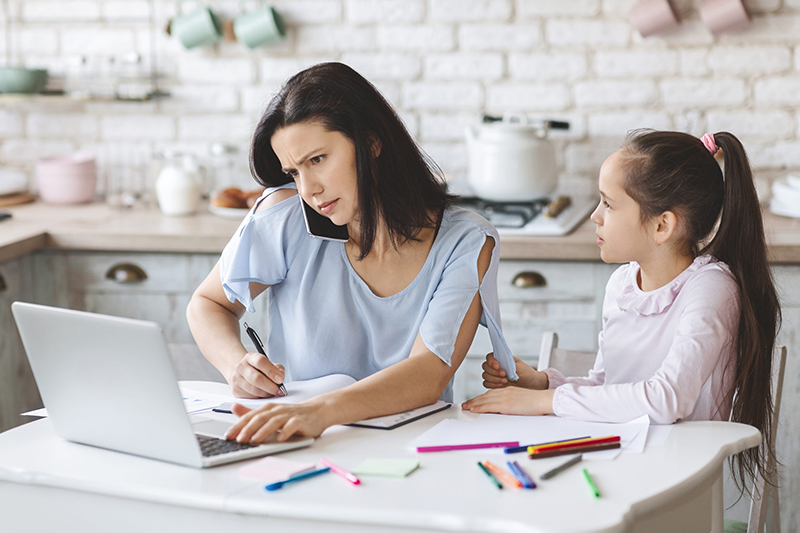 Mom trying to work at home while her daughter needs school help