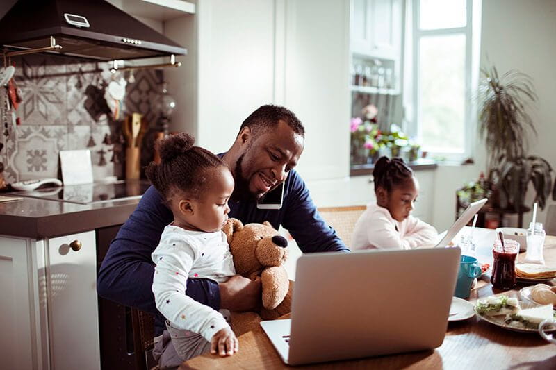 Dad trying to work from home while caring for his young kids