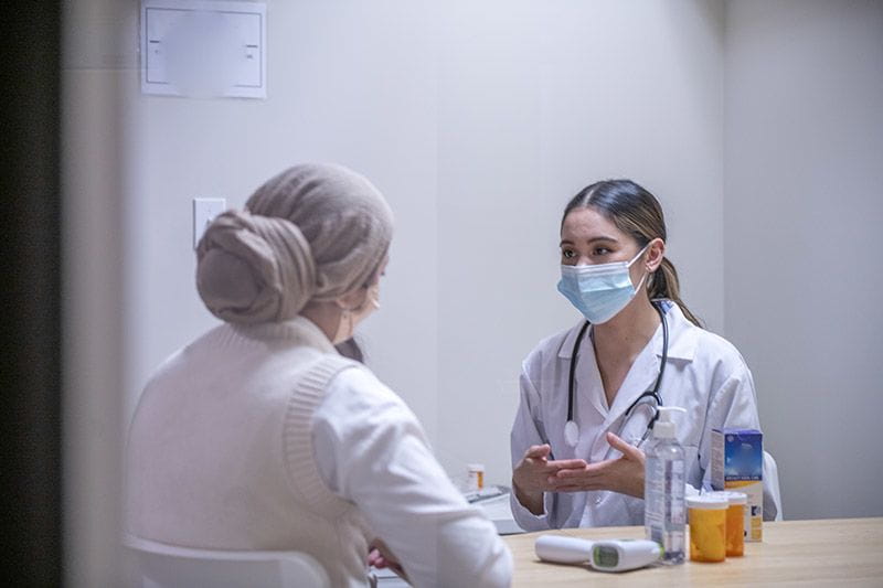 Female nurse practitioner consulting with a female patient