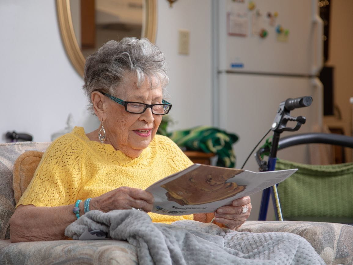 elderly woman reading health and safety questions