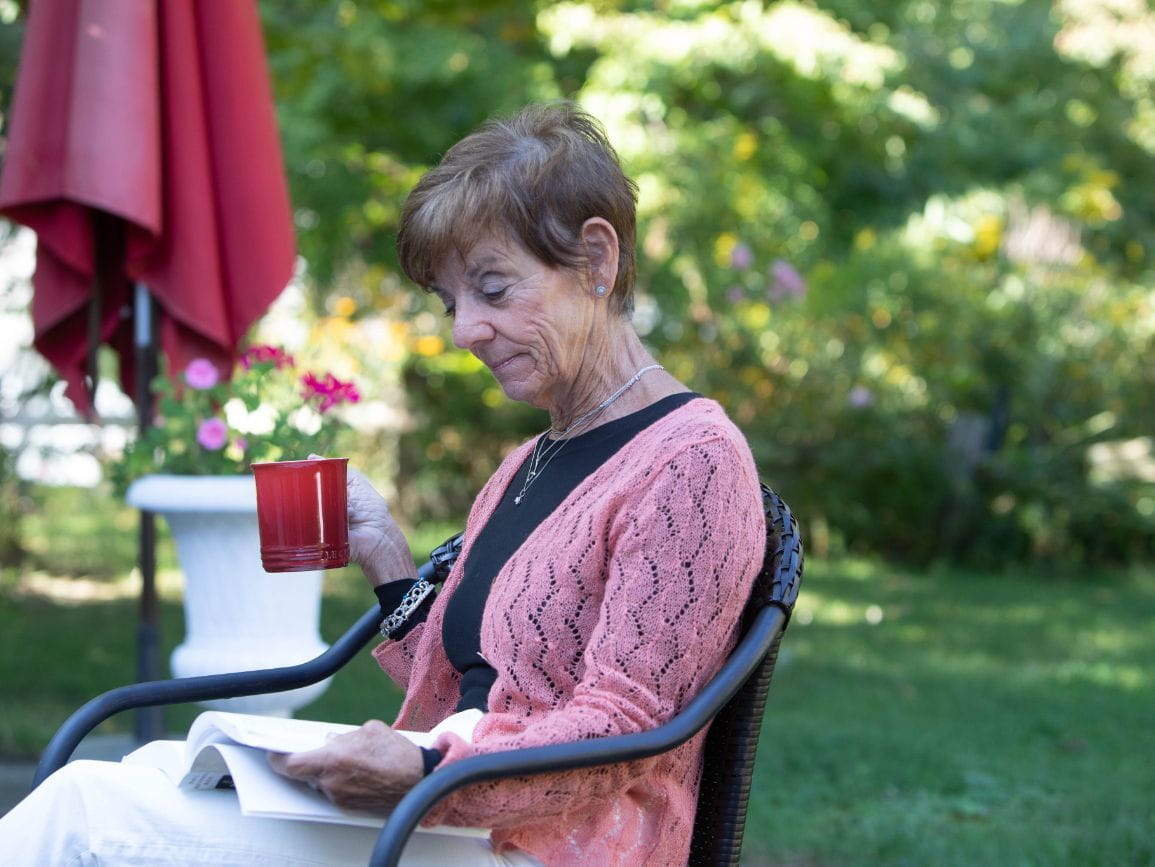 elderly woman sitting outside