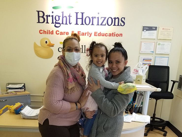 toddler and mom with a teacher in a mask