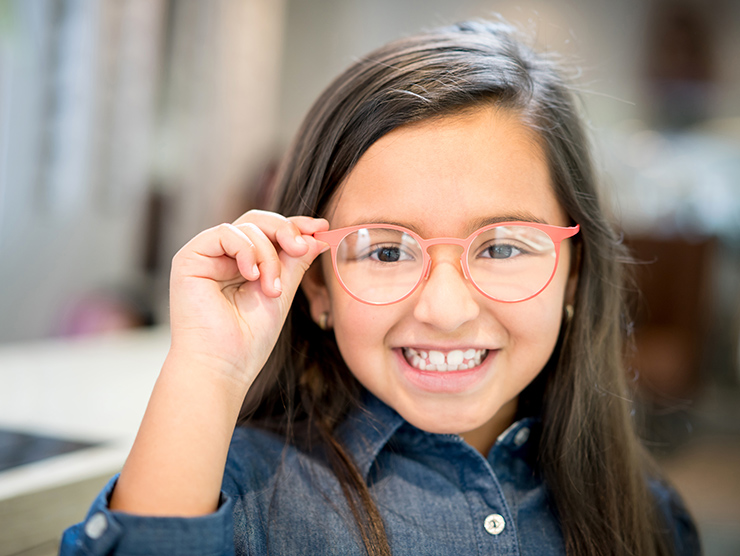 girl smiling with glasses on