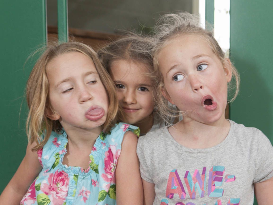 three toddler girls making funny faces