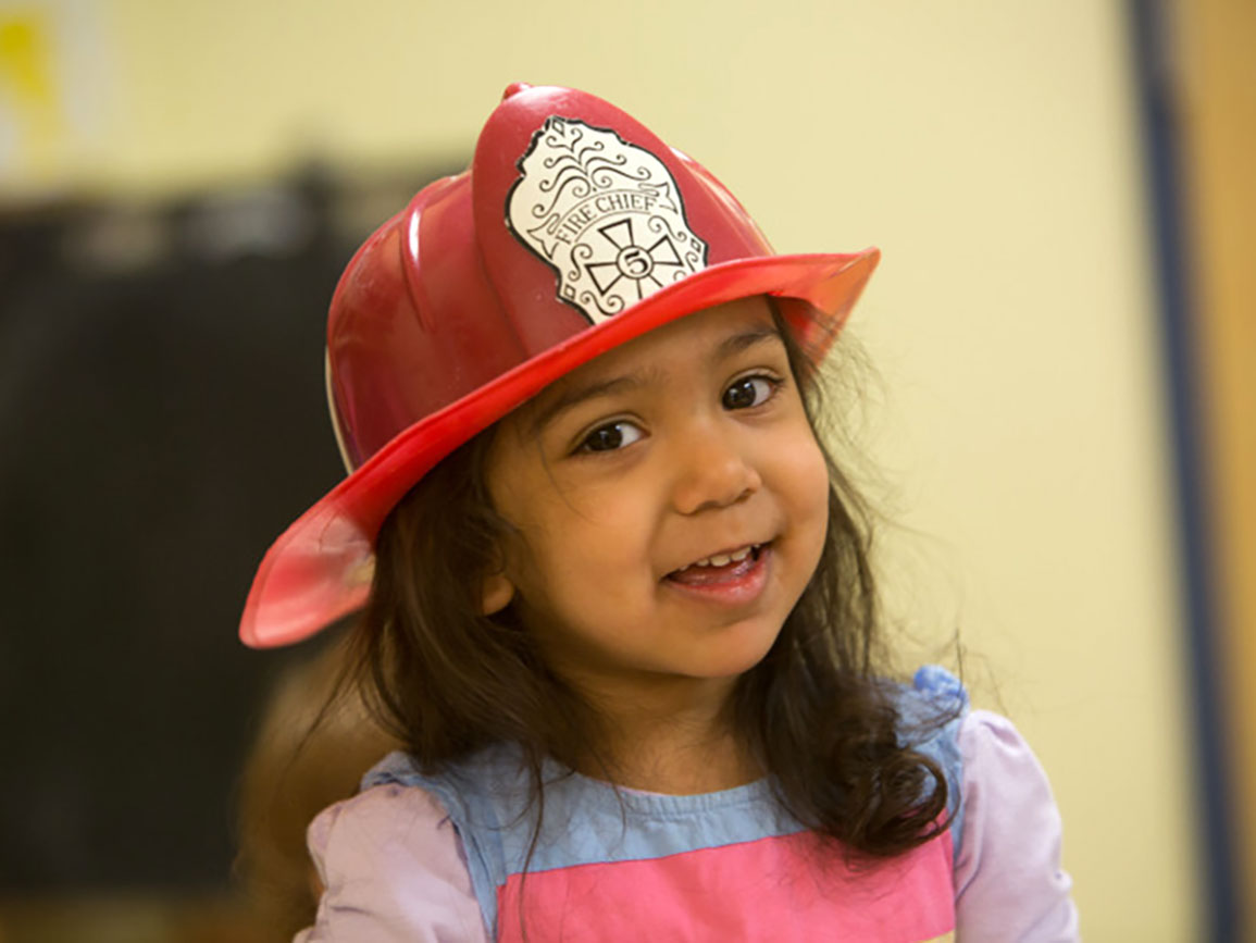 Preschool girl wearing a firefighter's hat