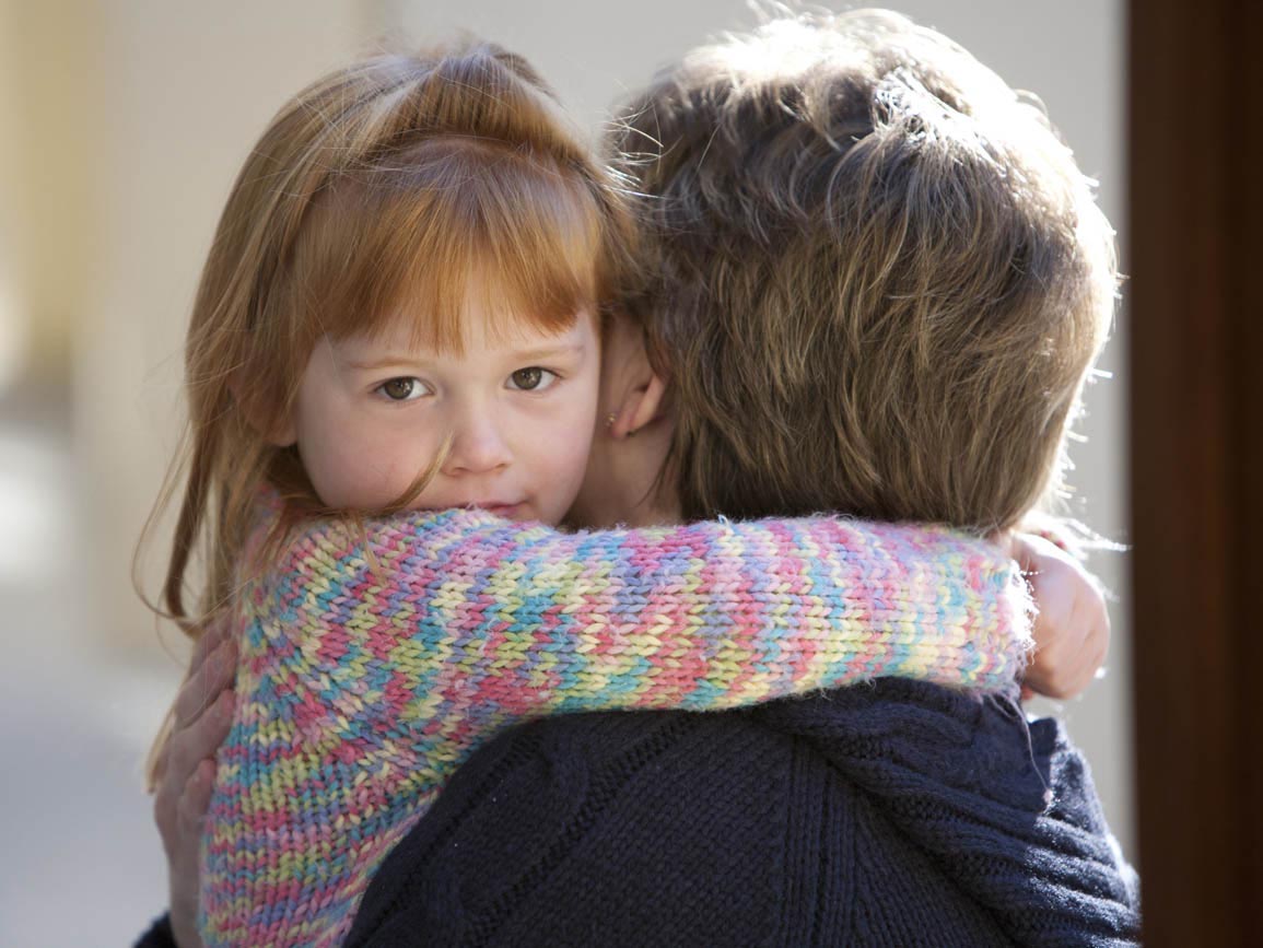A toddler hugging her parent