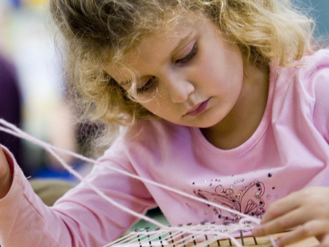 a girl crafting with yarn