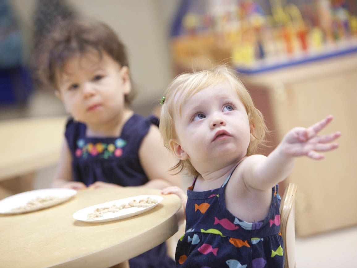 Young toddler girls at the snack table