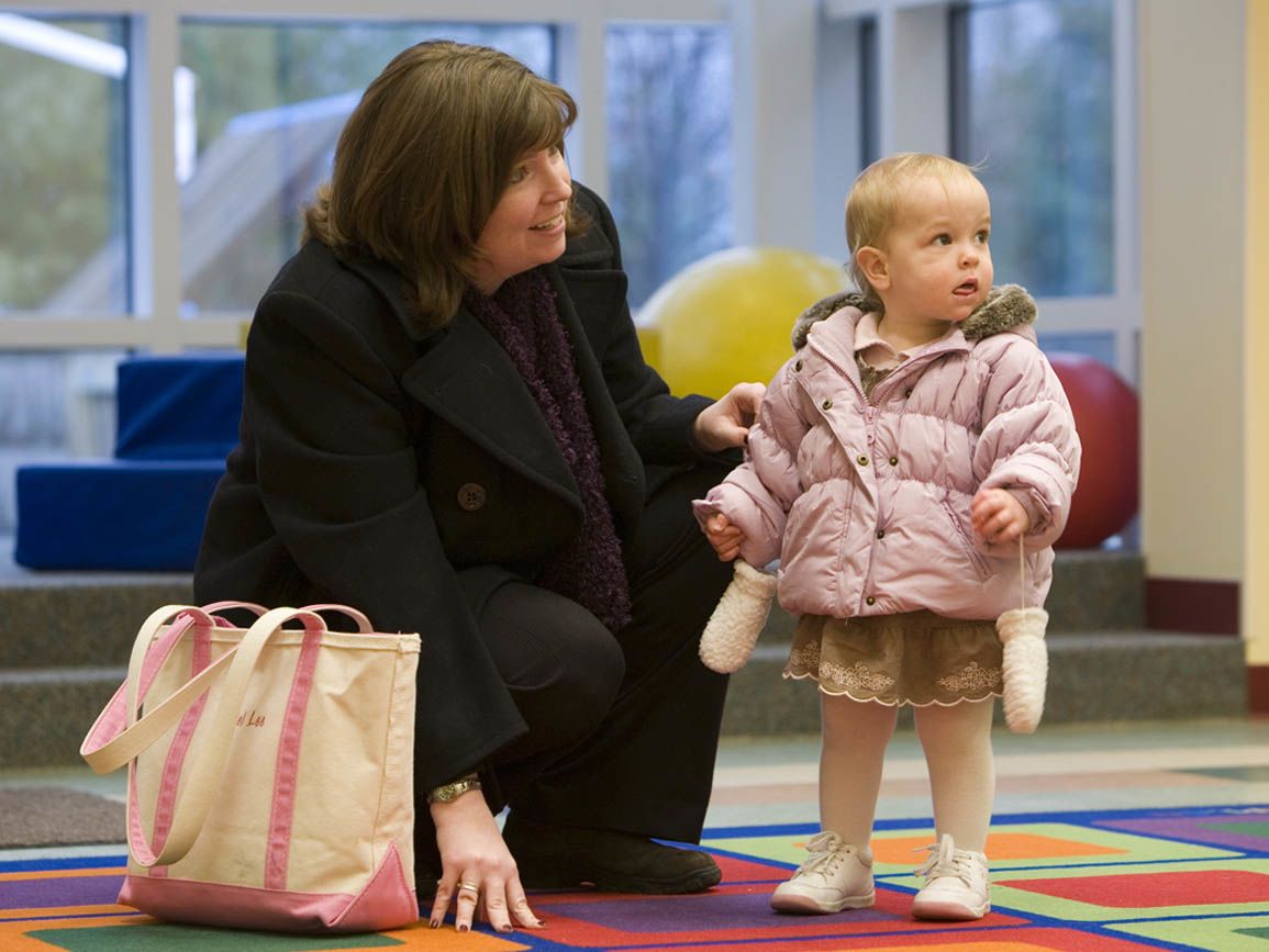 A mother and her infant daughter at the airport